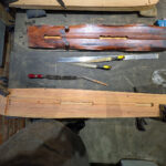 Underside of the guqin being shaped next to a finished model.