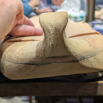 Rear view of the tuning peg protector after carving is complete.