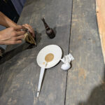 Raw lacquer being mixed with solvent for initial seal coat.