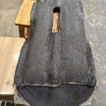 Bottom view of cotton mesh fabric embedded in lacquer cement for added strength.