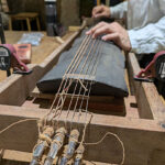 First sound test of the guqin after multiple layers of lacquer cement have been applied.